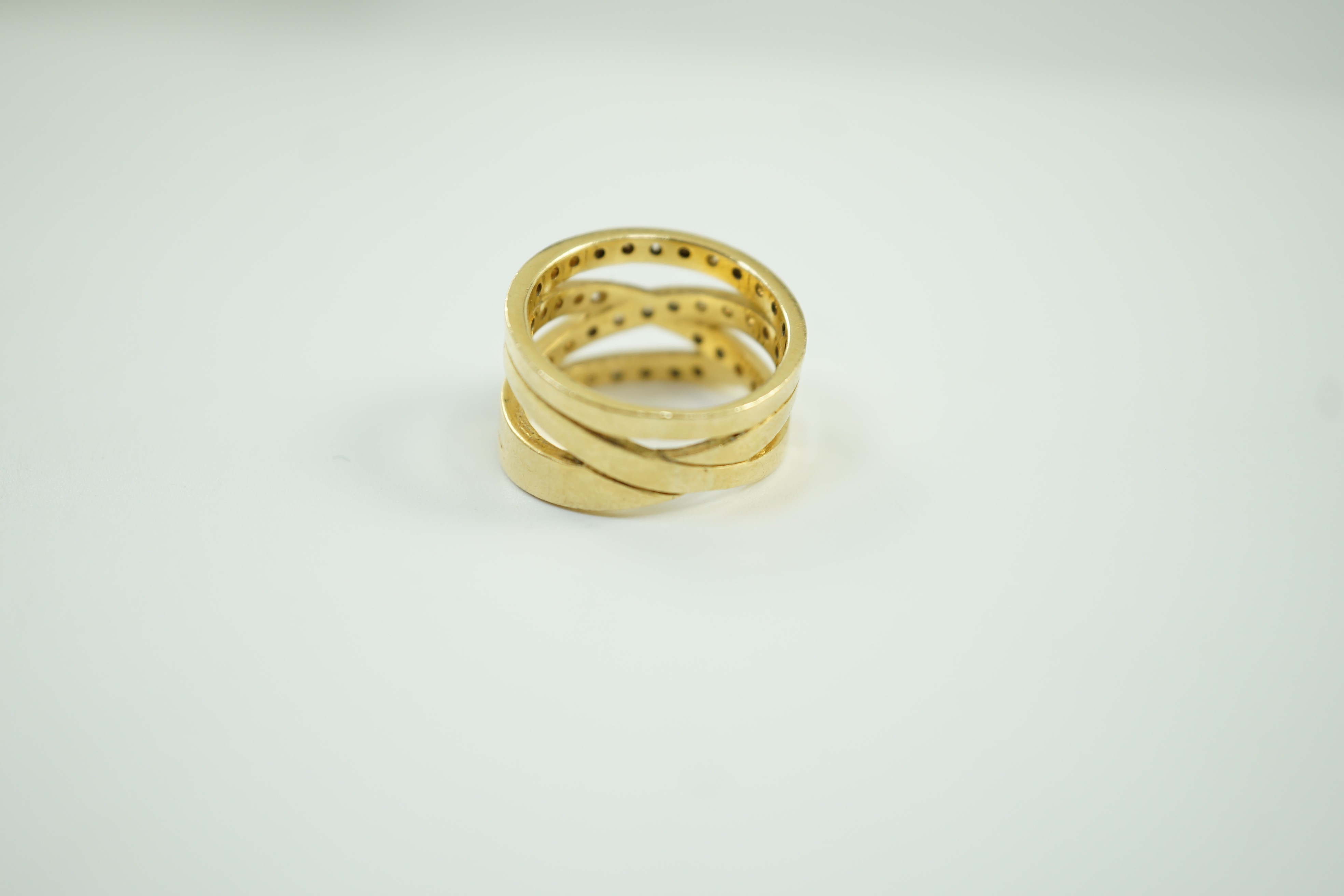 A modern 750 and diamond chip cluster set multi shank dress ring, size P, gross 10.1 grams.